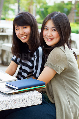Buy stock photo University, smile and portrait of girl students with scholarship sitting outdoor on campus for education. Knowledge, happy and Japanese female college friends bonding in a park or garden with books.