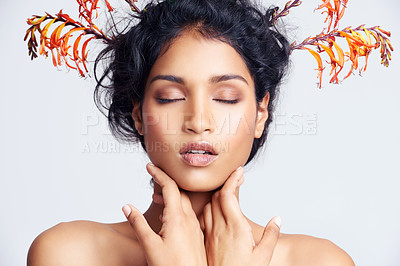 Buy stock photo Studio shot of a beautiful young woman with colorful branches in her hair