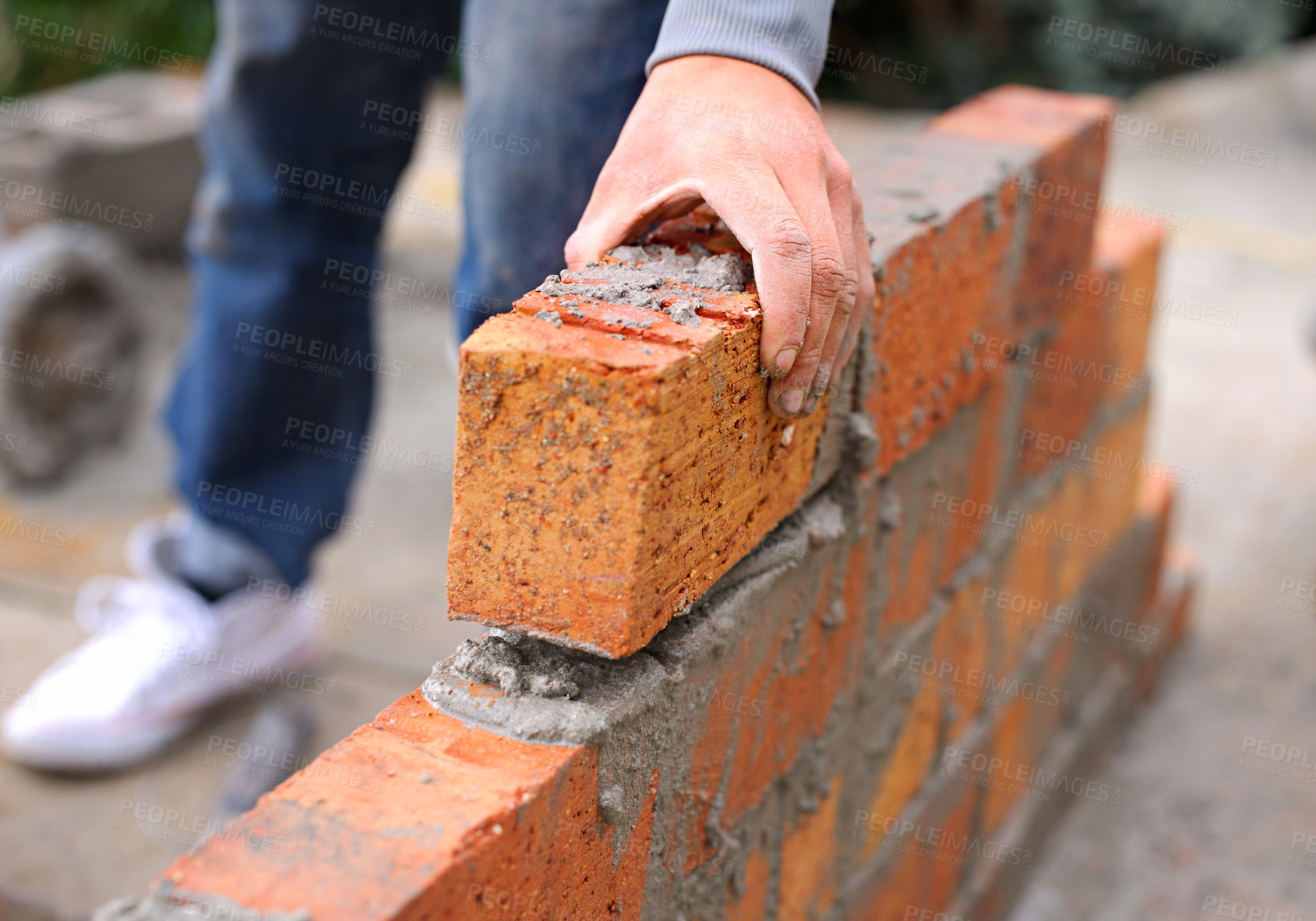 Buy stock photo Bricklayer, hand and construction with man builder on roof, working employee in industrial industry and contractor career. Outdoor, cement on site with handyman staff, skilled masonry with bricks