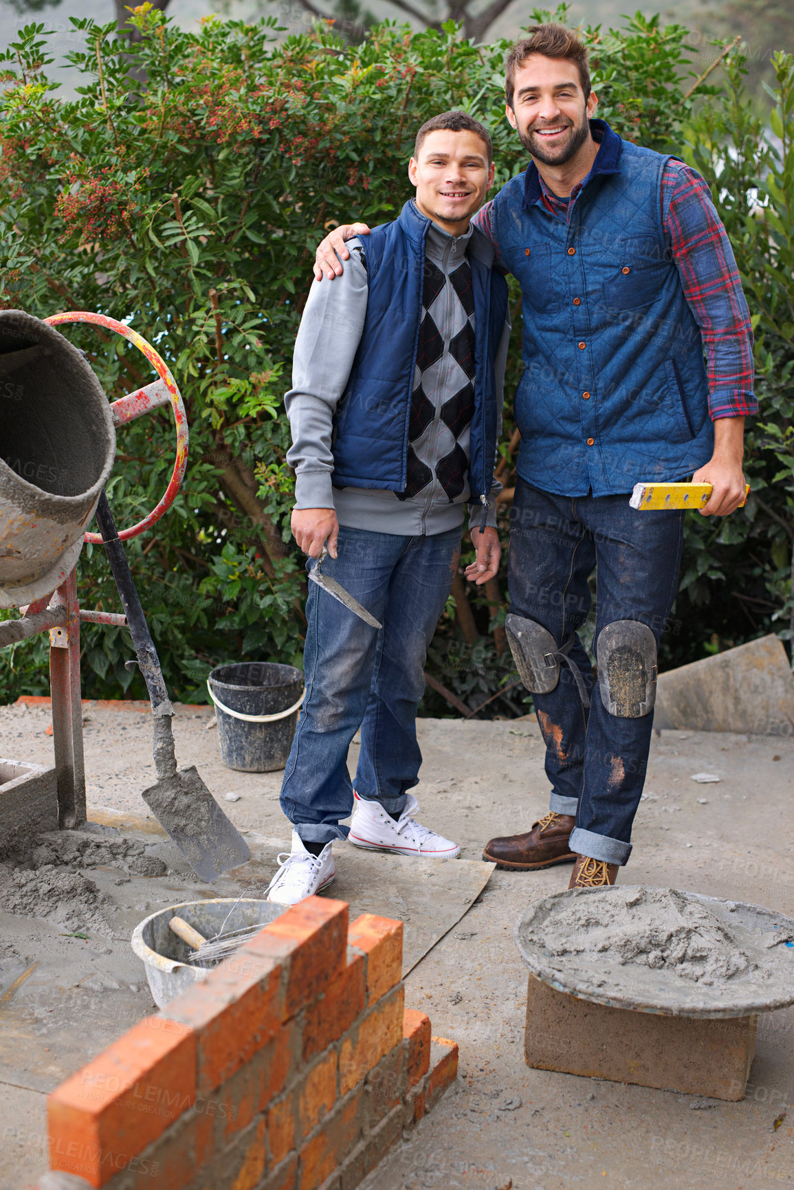 Buy stock photo Portrait of a bricklayer and his apprentice at work