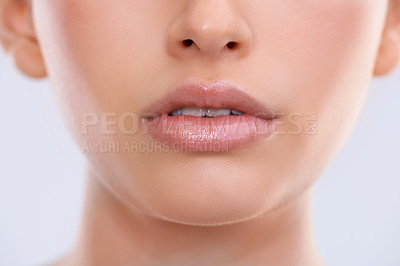 Buy stock photo Closeup, face and lips with woman for beauty, makeup with shine and cosmetics for dermatology on white background. Skin, lipstick or balm for moisturizer, skincare and glow for wellness in studio