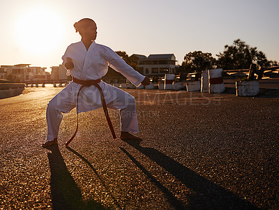 Buy stock photo A young woman in a gi practicing her kata