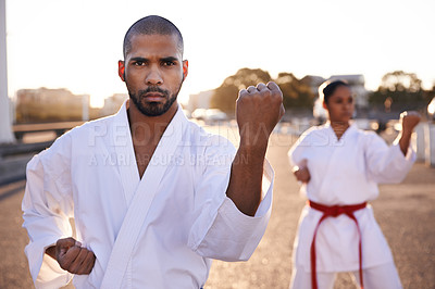 Buy stock photo Serious people, karate and martial arts with personal trainer for self defense, class or teaching in city street. Man and woman fighter or athlete in fitness training, kata or technique in urban town