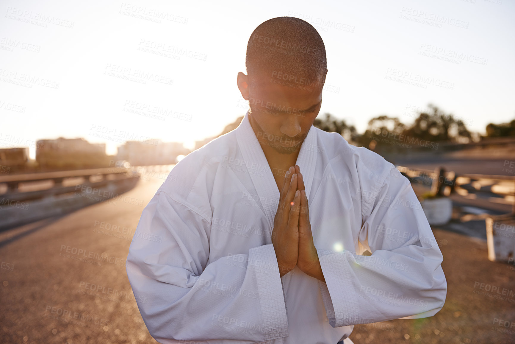 Buy stock photo A meditative young karate practitioner wearing a gi