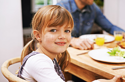 Buy stock photo Girl, child and smile in portrait at dinner table for eating, food and relax on holiday in family house. Kid, happy and people in dining room for lunch with nutrition, diet and together in home