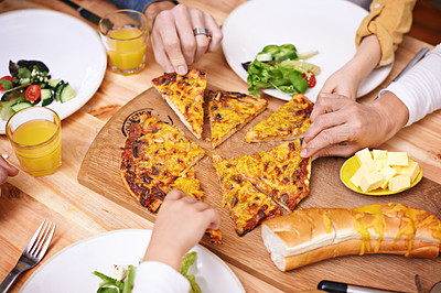 Buy stock photo Hands, pizza and top view of family eating food at table in home for lunch or hungry for bread. Margherita, group and people with mozzarella slice for dinner with salad on plate, cheese and closeup
