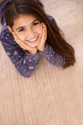 Buy stock photo Children, portrait and girl relax on a floor, carpet or relax in her home for vacation, resting or break from above. Top view, face and excited female kid person in a living room for weekend chill