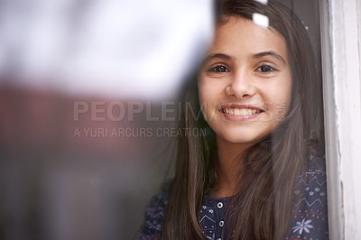 Buy stock photo Happy, window and portrait of child in home for relaxing, rest and calm on weekend. Youth, smile and face of young girl by glass for view, thinking and reflection for happiness, playing and childhood