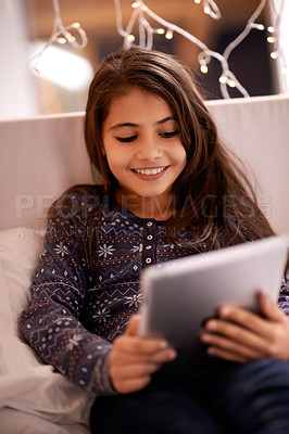 Buy stock photo Girl, kid and tablet, technology and communication with ebook for reading and social media at home. Elearning, movie or storytelling app with internet, browsing and digital platform for gaming