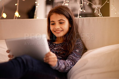 Buy stock photo Girl, kid and tablet, happy with tech and relax on sofa with ebook for reading and social media at home. Elearning, cartoon or storytelling app with internet, browsing and digital platform for gaming