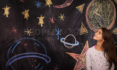 Buy stock photo Shot of a little girl standing in front of a chalkboard drawing