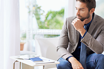 Buy stock photo Shot of a thoughtful businessman at the office