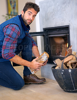 Buy stock photo Fire, log and portrait of man at fireplace for heat, warmth and light in winter in home. Season, burning and person with firewood, flame wood for comfortable, cozy and relaxing house in living room