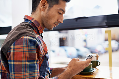 Buy stock photo Man, hands and phone with coffee in social media, communication or networking at indoor cafe. Male person on mobile smartphone for online chatting, texting or app by window at restaurant or cafeteria