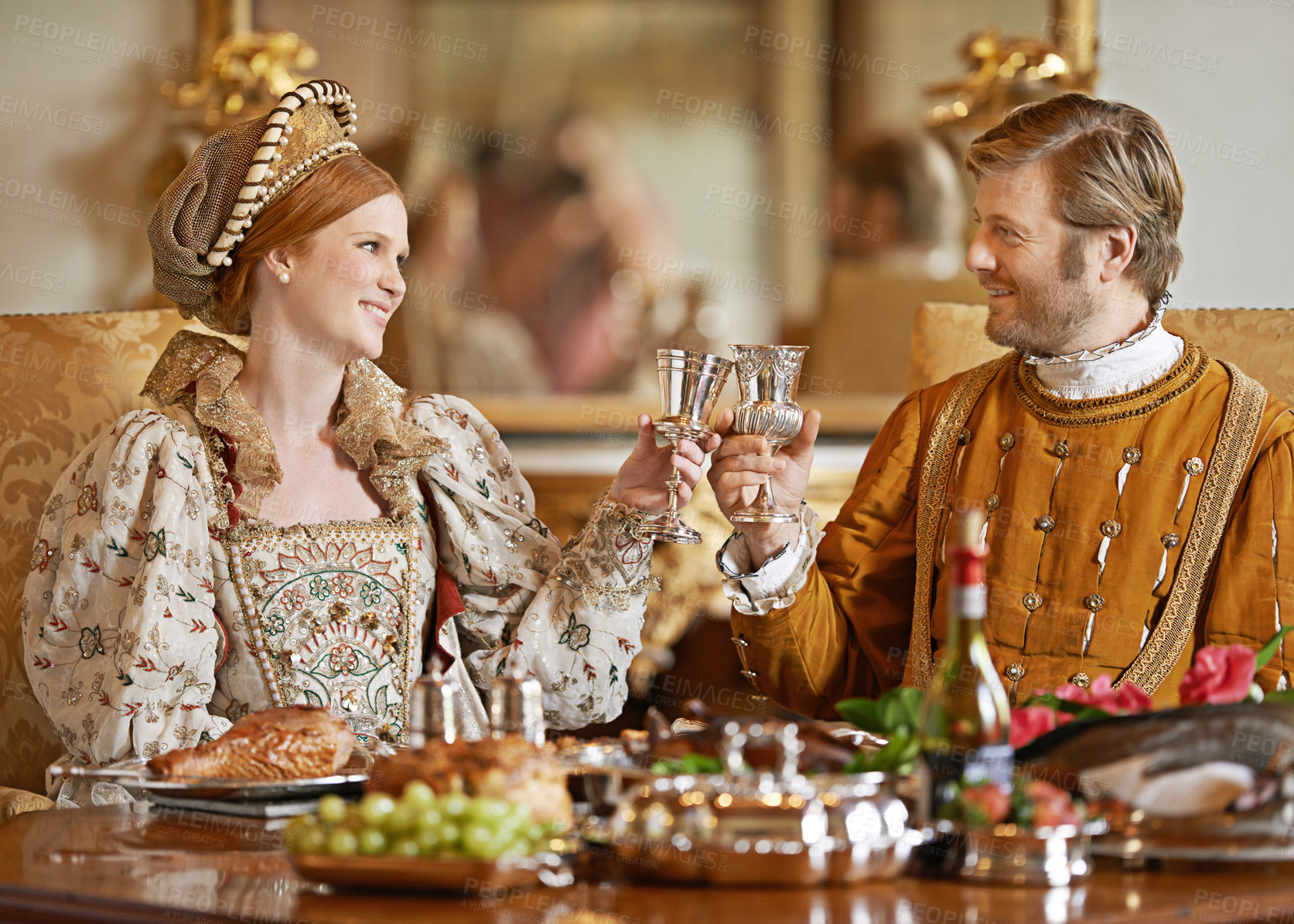 Buy stock photo Royal, king and queen in renaissance with luxury, wine and happiness with toast together for wedding night. Noble, man and woman with smile for wealth in marriage and girl with husband in palace