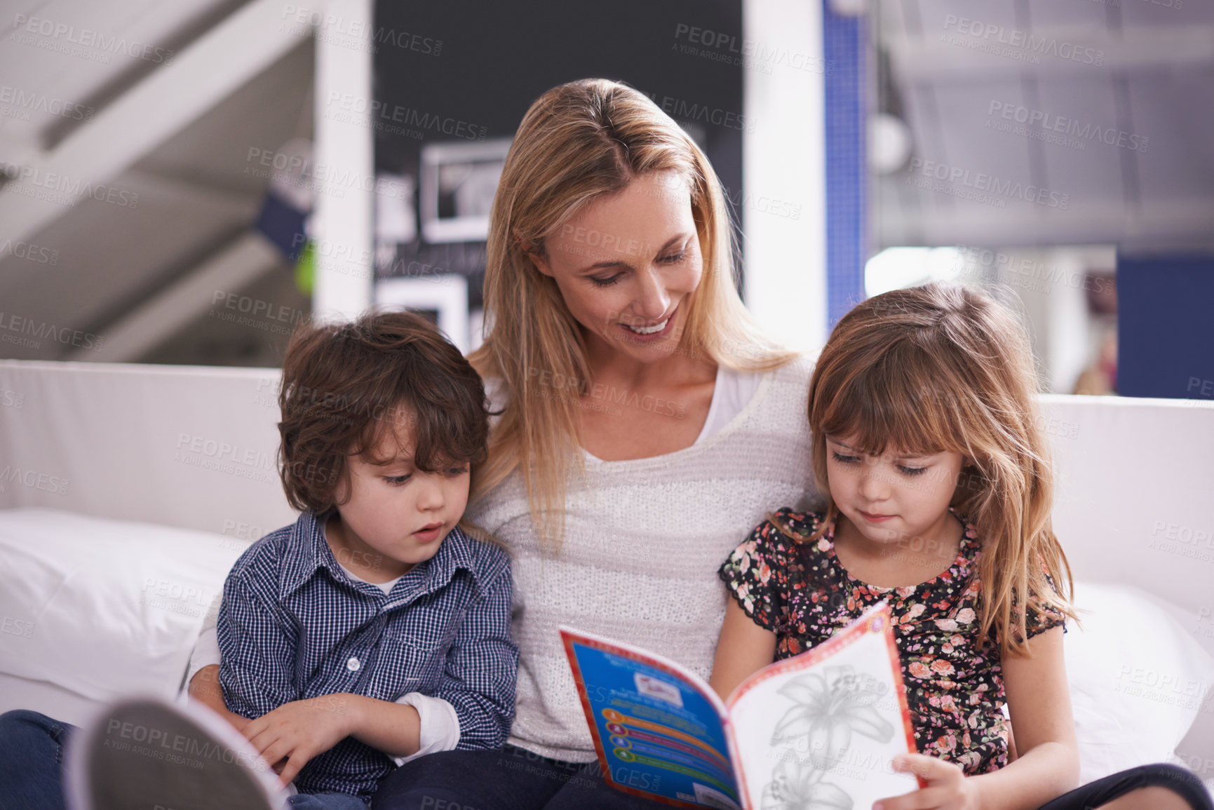 Buy stock photo Reading, mom and children on sofa with book for bonding, teaching and learning together in home. Woman, son and daughter relax on couch for bedtime storytelling, smile and happy family in living room
