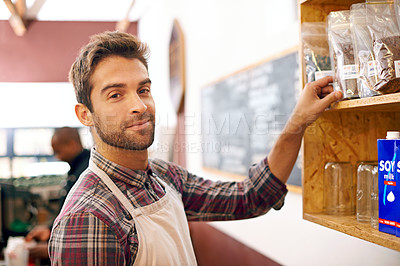 Buy stock photo Man, barista and portrait by a shelf in coffee shop with smile for service, search and ingredients for drink. Waiter, person or small business owner in cafe with product, beans and happy for choice 