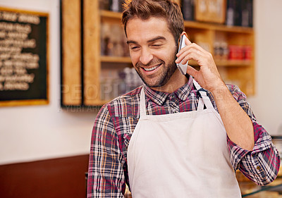 Buy stock photo Man, coffee shop and barista with phone call, smile and talk to contact for drink order at small business. Person, waiter and smartphone to listen for conversation, networking and happy in cafeteria