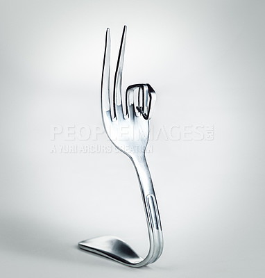 Buy stock photo A fork with bent prongs isolated on grey