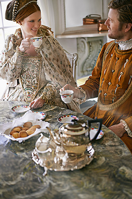 Buy stock photo A king and queen taking tea together at home