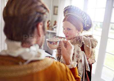 Buy stock photo Man, woman and royal costume for tea party with conversation, vintage clothes and style in castle. King, queen and couple with drink together in morning with Victorian fashion at regal palace in UK