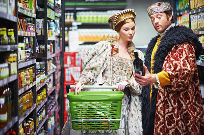 Buy stock photo Supermarket, king and queen with wine, decision and costume with conversation and inflation. Royal couple, man and woman with choice and alcohol with shopping and customers with expensive product