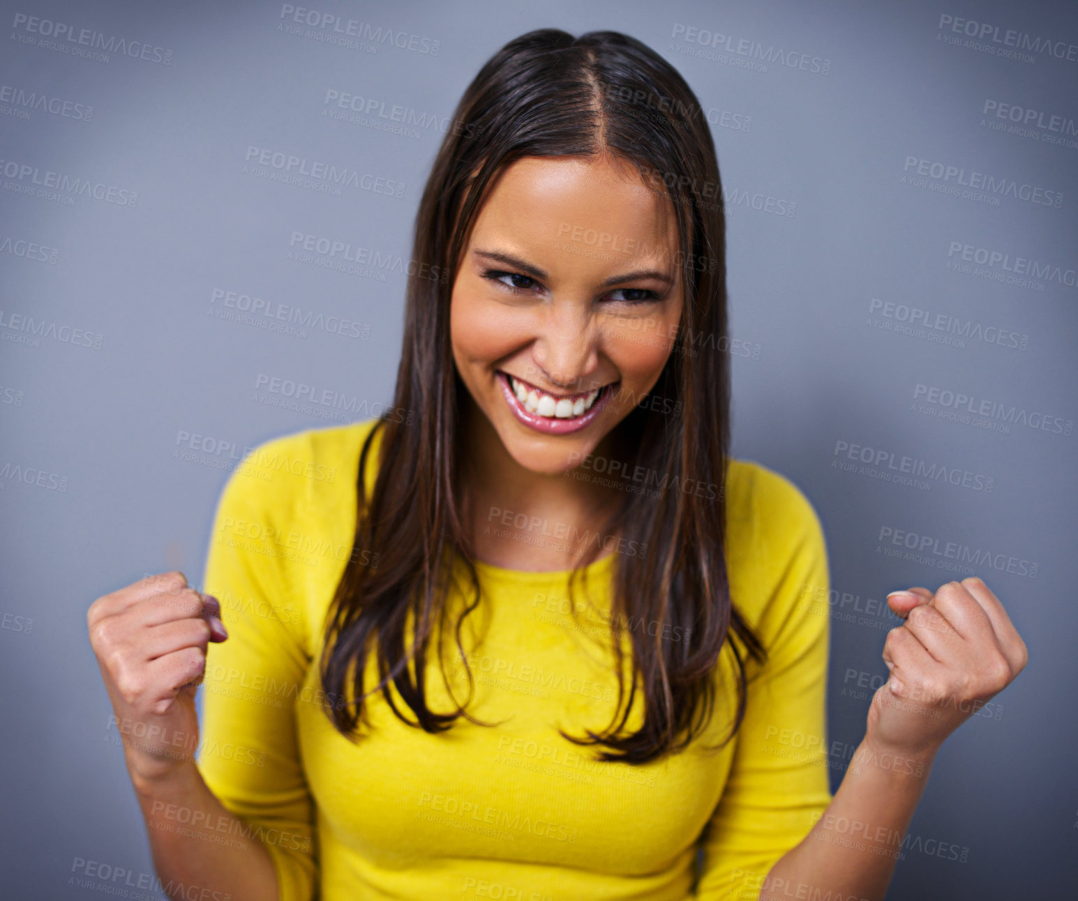 Buy stock photo Woman, fist and celebration with smile in studio for success, goals and vision for achievement by blue background. Girl, person and winner with cheers, thinking and excited with competition in Mexico