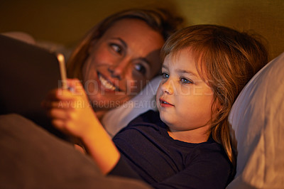 Buy stock photo Night, mother or kid with tablet for streaming, playing games or watching videos on movie website in home. Social media, child or happy mom with smile or technology to download on ebook online in bed
