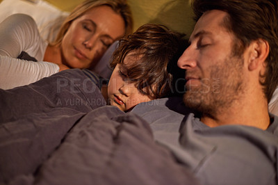 Buy stock photo Shot of a young family sleeping beside each other