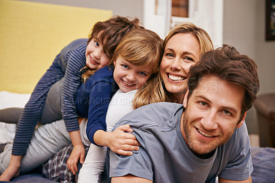 Buy stock photo Portrait of a young family being playful at home