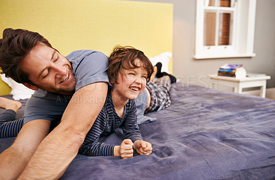 Buy stock photo Happy, playing and father with child on bed bonding, relaxing and having fun together at modern home. Laughing, smile and young dad laying with boy kid in bedroom on weekend at family house in Canada