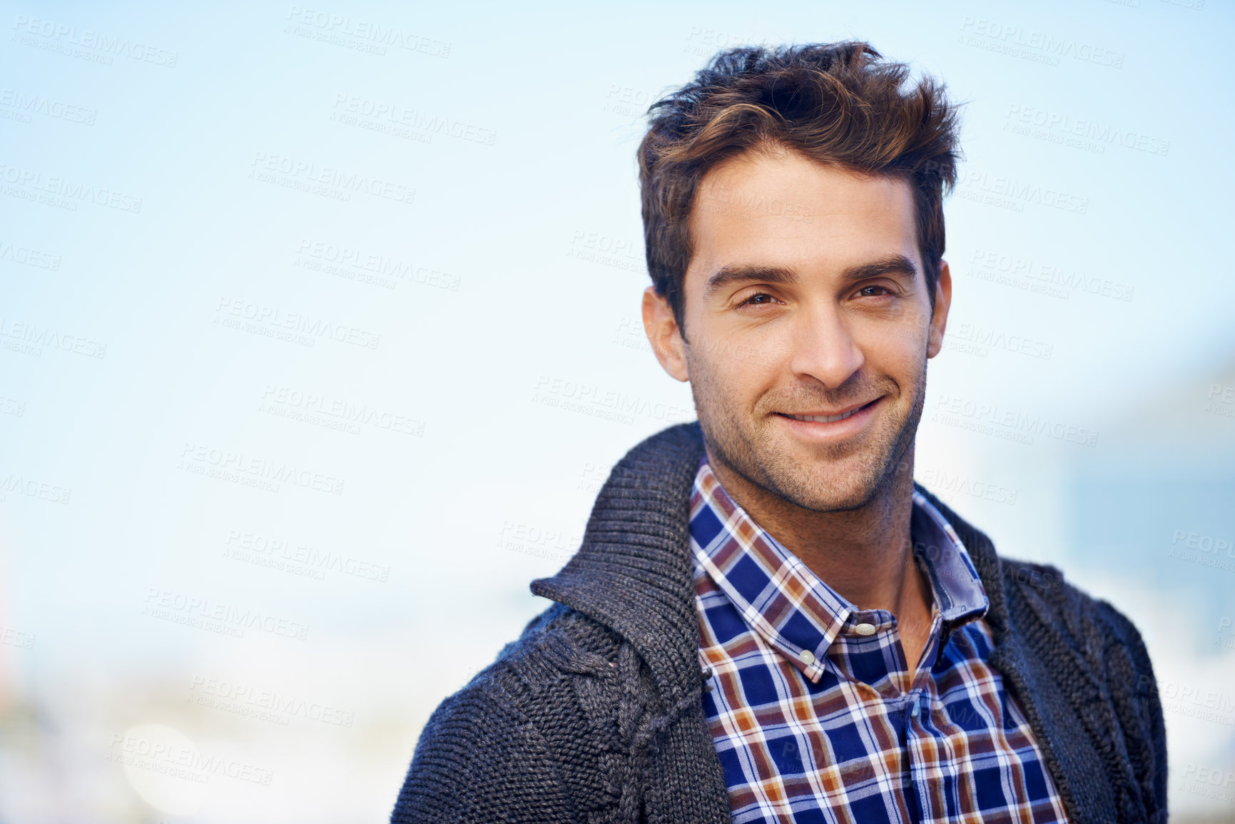 Buy stock photo Shot of a handsome young man spending a day outdoors