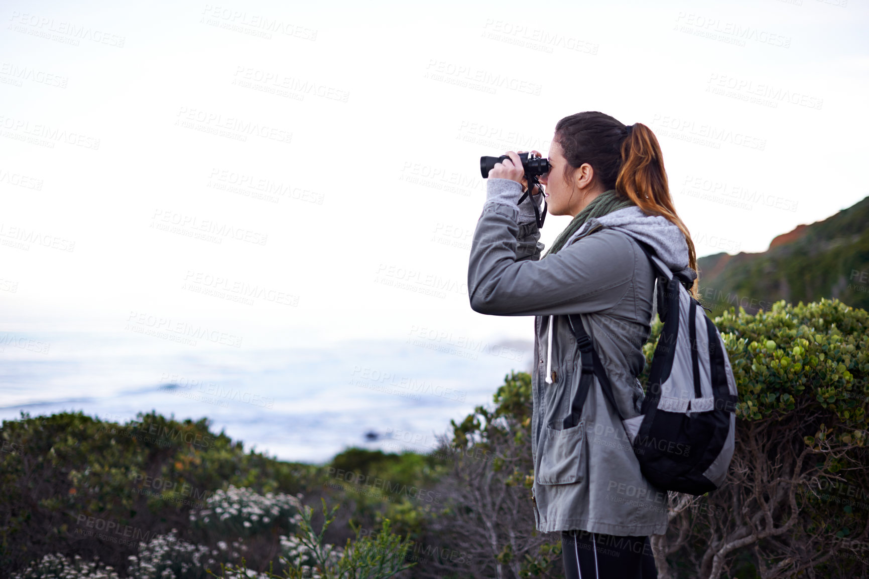 Buy stock photo Woman, mountain and binoculars in nature environment for trekking hike for holiday, explore or journey. Female person, workout and walking on wilderness path for healthy, backpacking or adventure