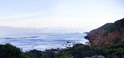 Buy stock photo Ocean, nature and mountain in environment outdoor for vacation, holiday and travel in South Africa. Sea, water and waves with landscape, blue sky and mockup space in the countryside at coastline