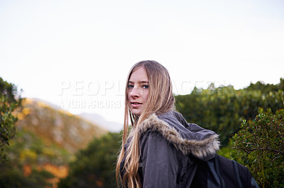 Buy stock photo Portrait, outdoor and hiking with woman, countryside and relaxing with weekend break and mountains with hobby. Face, person or hiker with flowers and healthy with wellness or activity with nature