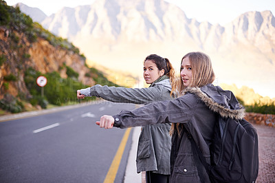 Buy stock photo Highway, nature and friends hitchhiking, backpack and women together for trip in Cape Town. Adventure, adult and girl with female person for holiday on road for with sign or thumbs up for travel