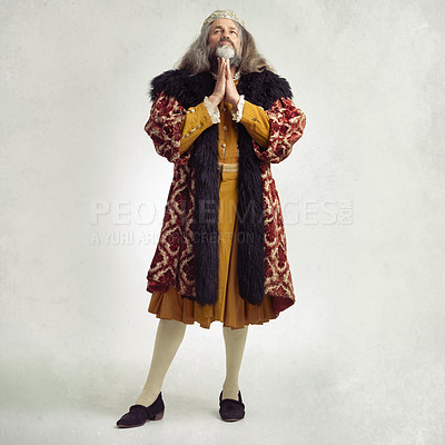 Buy stock photo Ancient king man, praying and studio with faith, worship and renaissance fashion by backdrop. Medieval royal leader, clothes and religion with crown, prayer and robe for power, success and gratitude