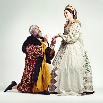 Buy stock photo Studio shot of a king proposing to a royal lady