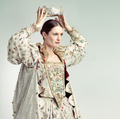 Buy stock photo Shot of queen holding a crown over her head