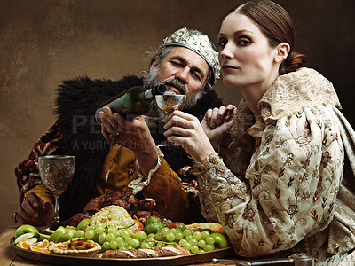 Buy stock photo King, queen and portrait with wine at table for fine dinning in royal banquet, vintage and majestic with crown. Monarch, husband and pour alcohol for buffet or feast for formal celebration and drink.