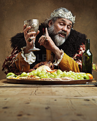 Buy stock photo King, feast and drunk in table with wine glass for dinner on dining hall for tradition, culture and meal in palace. Monarch, leader and eating buffet or supper on royal party as lord with crown.
