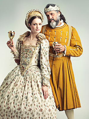Buy stock photo Studio portrait of a king and queen drinking out of goblets