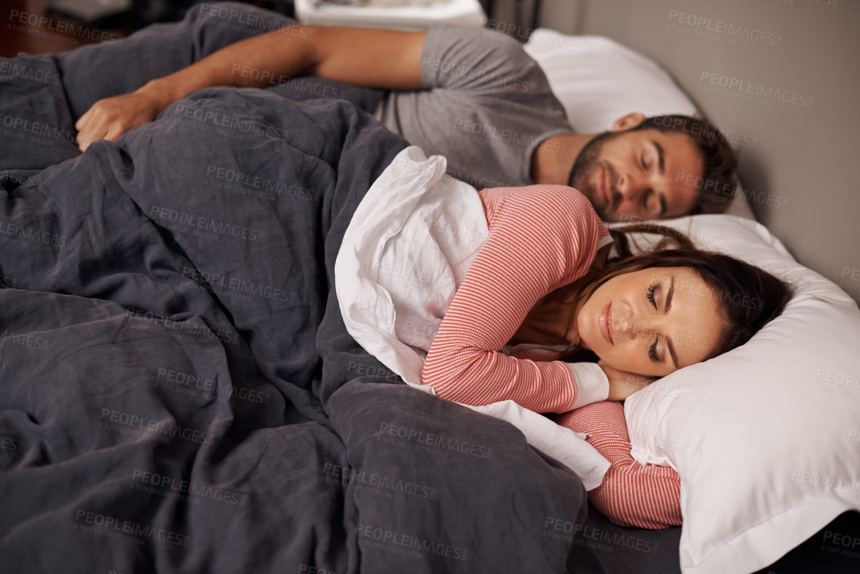Buy stock photo Couple, sleeping and tired in bed, home and rest with dream, peace and quiet on holiday together. Man, woman and lying with blanket in bedroom for vacation with pajamas at apartment in Argentina