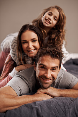 Buy stock photo Parents, kid and portrait in bedroom to relax in home for weekend break, family time and happiness for bonding. Father, mom and girl child comfy or cozy together for love, care and safety or security