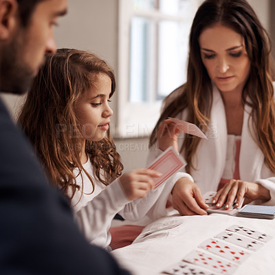 Buy stock photo Mom, father and girl with playing cards in home with bonding, learning and relax with strategy in bedroom. Dad, mother and daughter with deal, game and teaching on bed with connection in family house