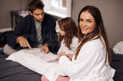 Buy stock photo Parents, girl and game of cards for portrait in home with bonding, learning and happy for strategy in bedroom. Dad, mother and daughter with deal, deck and child on bed with playing in family house