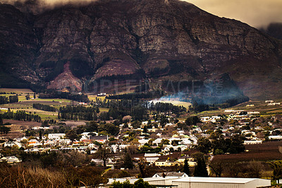 Buy stock photo Urban development, suburb or cityscape by mountain, buildings and housing in Cape Town. Outdoor, landscape and mountains with houses, night and hill for real estate, property or holiday by skyline