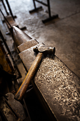 Buy stock photo Hammer, anvil and blacksmith workplace in a iron factory and industrial workshop. Tools, metal work and steel artisan bench with craftmanship equipment to forge in warehouse with metals and materials