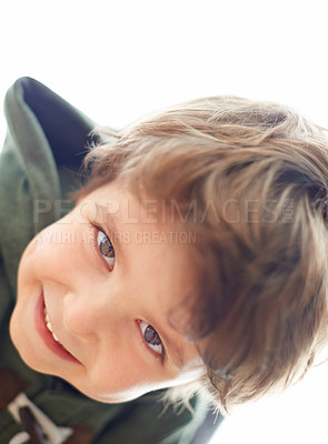 Buy stock photo A young boy leaning over to look at the camera