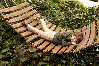 Buy stock photo Kid, boy and happy with lying on hammock outdoor for fun to play, child development and growth. Children, holiday and tree with smile for joy to sing on summer vacation or break for leisure at home